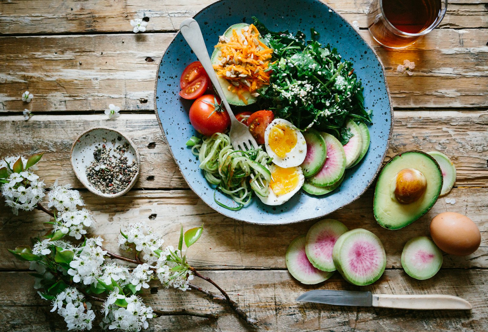 A balanced plate of greens, eggs, tomatoes, and vegetables